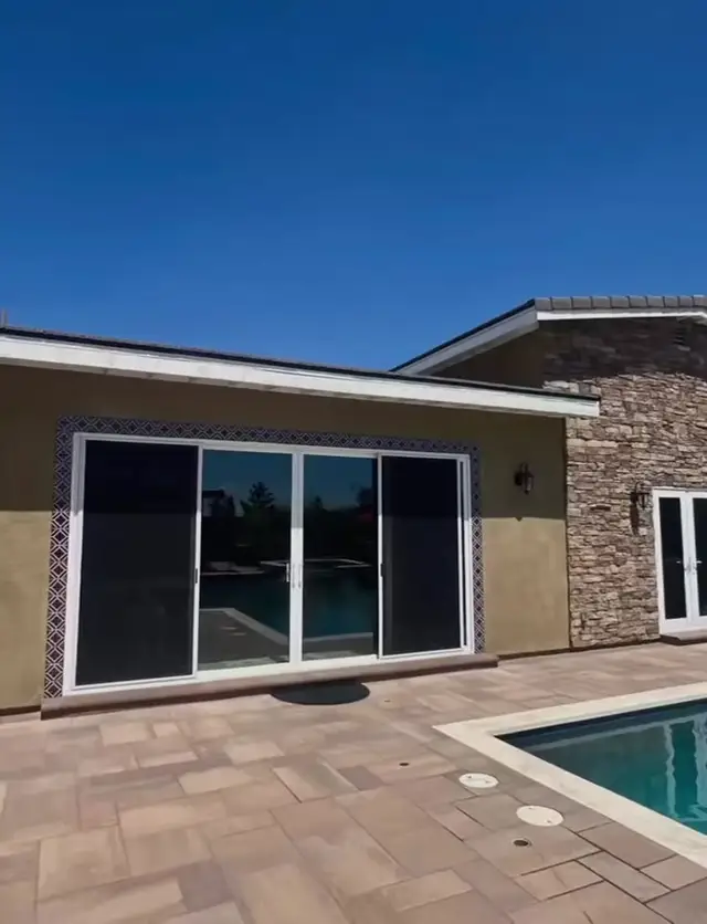ADU and pool house with sliding doors to the pool deck in Fontana