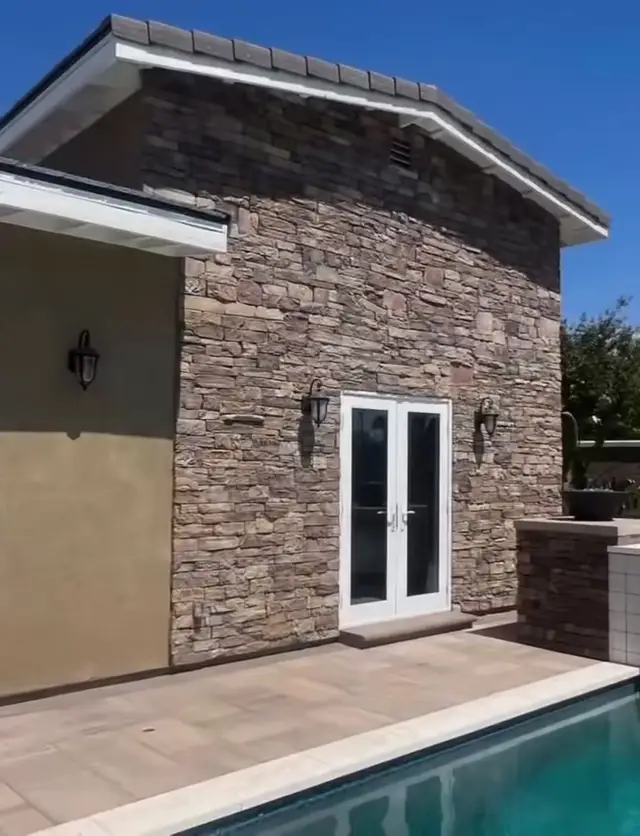 Stone-faced gable with French doors to the pool