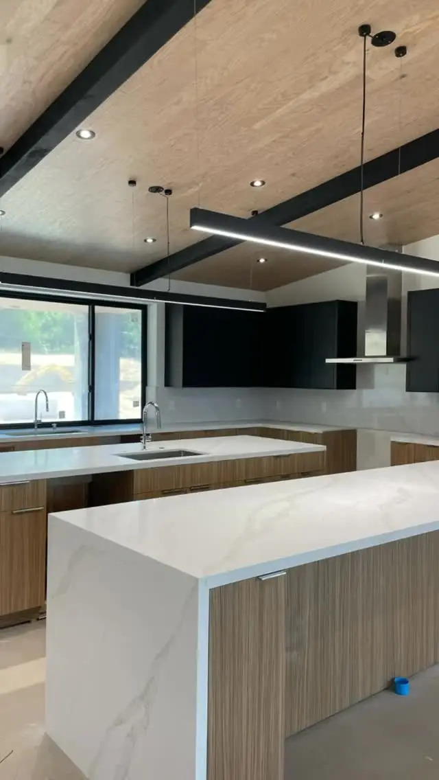Three-island kitchen with a waterfall edge
